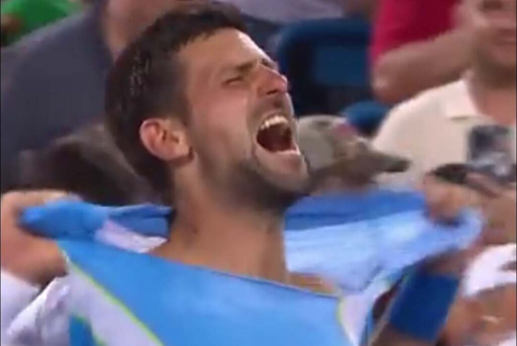 Novak Djokovic toring his t-shirt