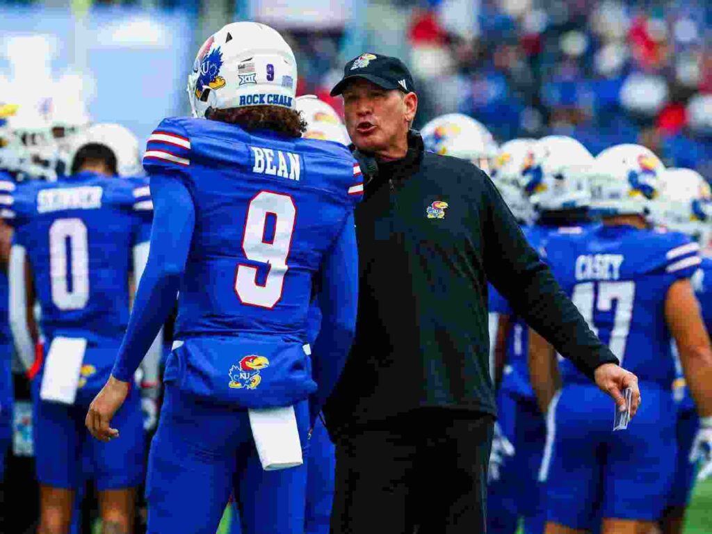 Kansas Jayhawks's Jason Bean with coach after winning the match