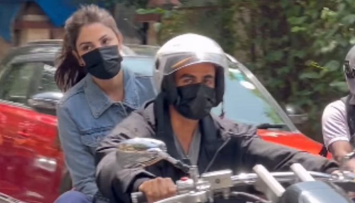 Rhea Chakraborty and Nikhil Kamath on a bike